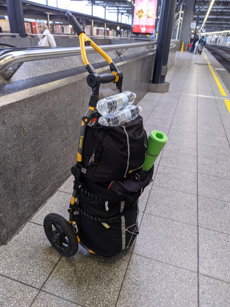 bicycle trailer/trolley with luggage in the midi station. On top waterbottles that will serve as weights for physio.