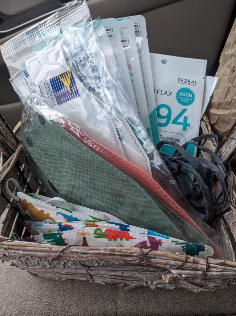 A basket containing an assortment of KF94, KN95, and N95 style respirator masks.