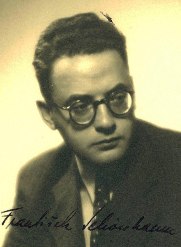 Vintage portrait of a man wearing glasses, with a detailed signature at the bottom.