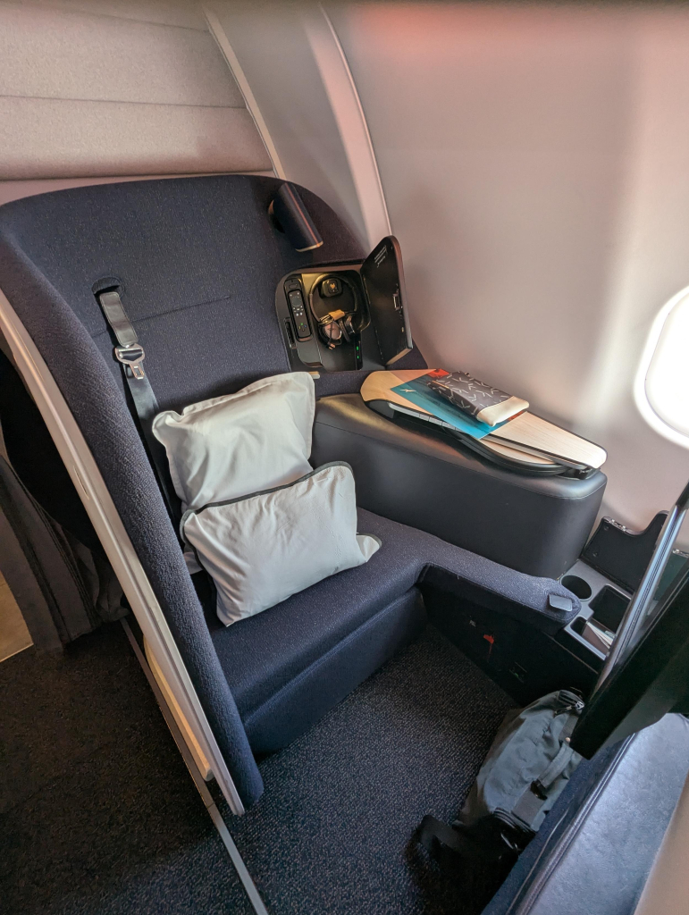 Photo of a Finnair business class seat, essentially a semi enclosed cubicle.