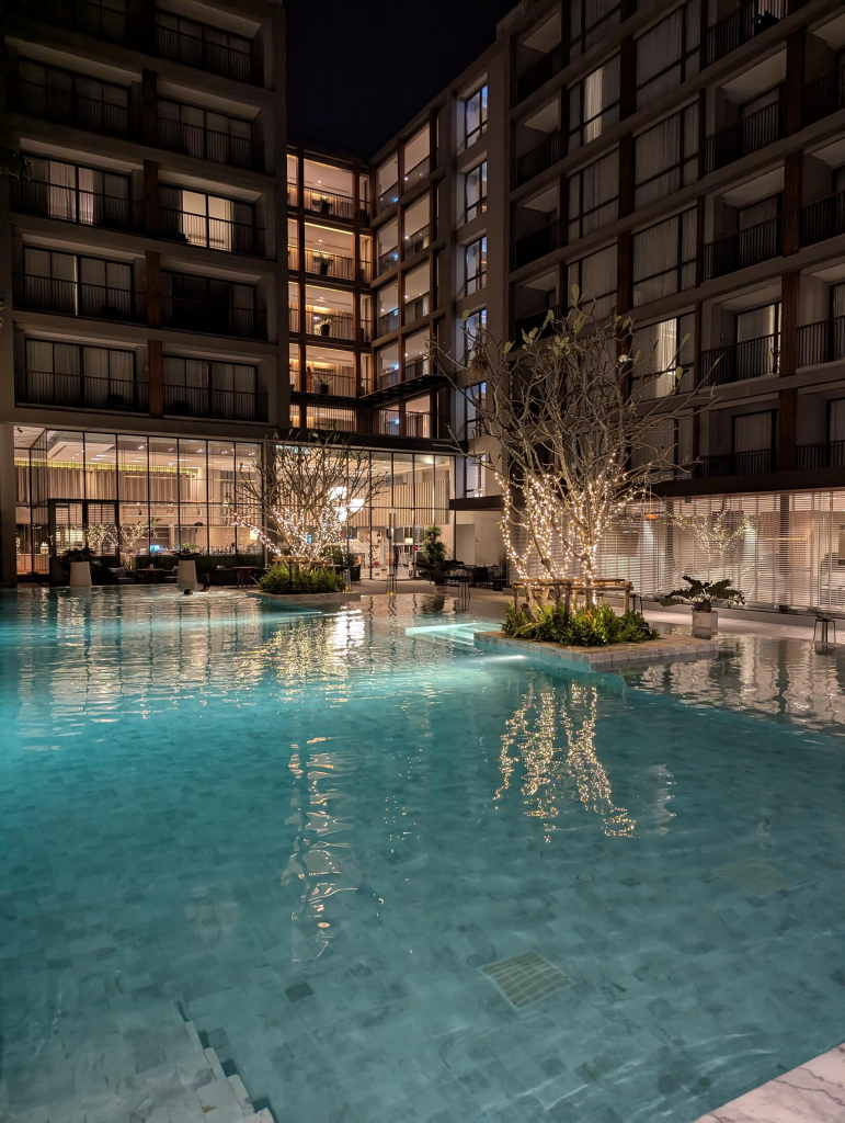 Photo of a hotel swimming pool and bar area from next to the pool.