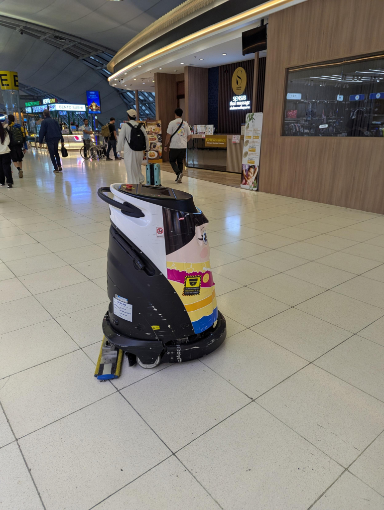 Photo of a robotic floor cleaning machine from the side.