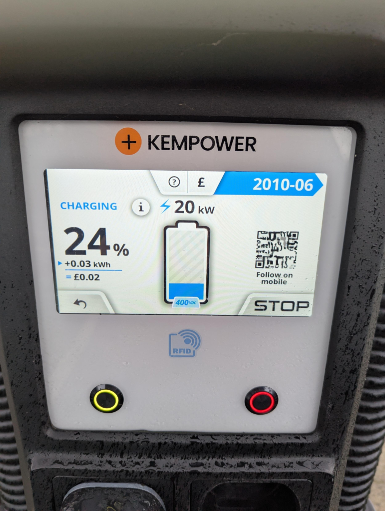 Photo of the screen on a Smart Charge/Kempower charger just after a charging session has started. There is a QR code on screen, with an invitation to "Follow on mobile"