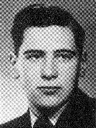 Black and white portrait of a young man with a serious expression, wearing a dark suit and tie.