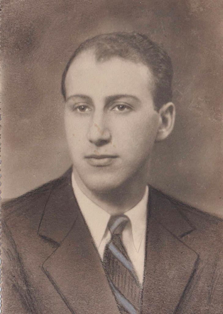 Vintage sepia-toned portrait of a young man wearing a formal suit and tie.