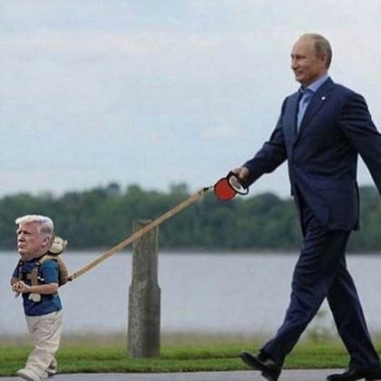 Horizontal PhotoShopped photo:
Russian leader Vladimir Putin (right) walks Trump (left), who is the size of a 3-year-old child, on a dog lead.
They're walking a path alongside what appears to be a canal, or perhaps the Potomac River.