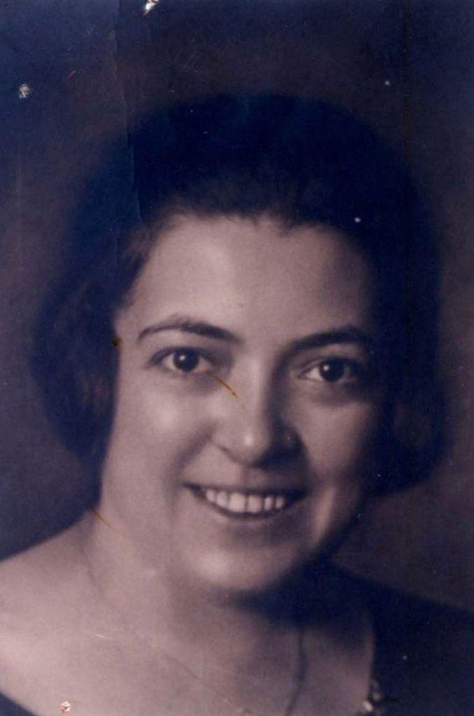 Vintage black and white portrait of a smiling woman with short hair.