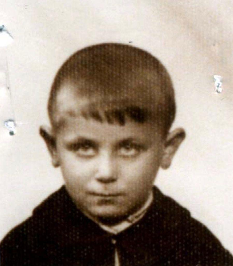 Vintage black-and-white photo of a young boy with a serious expression