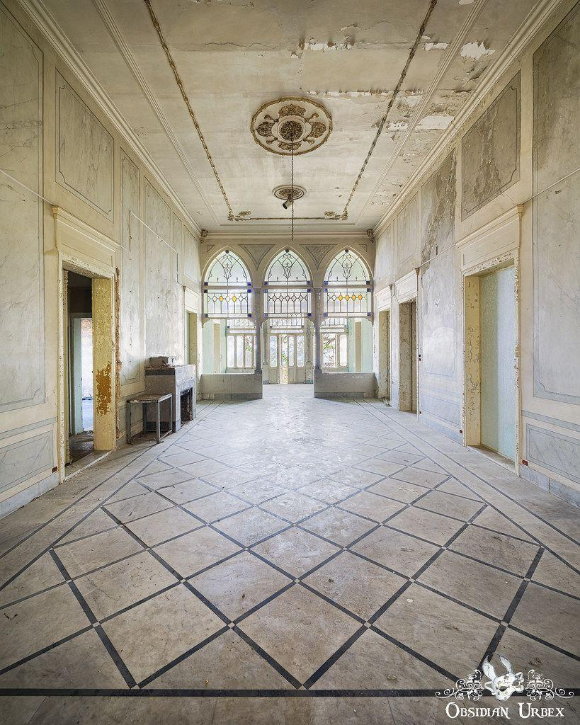 large white room with triple arch at far end