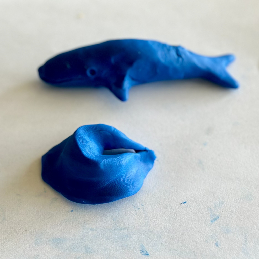 A photo of a ingot-shaped dumpling next to a whale