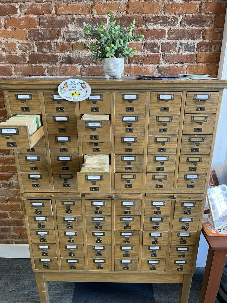 An old card catalog is used to hold seed packets.  