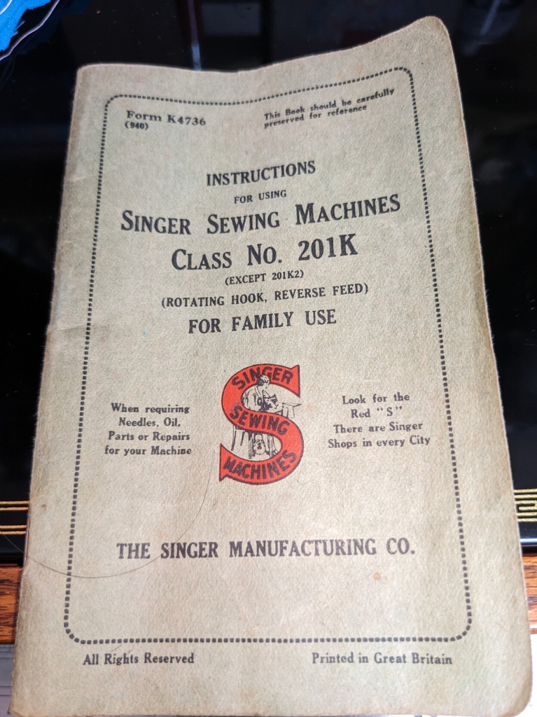 Small pale green paperback booklet. The main title is "Instructions for using Singer sewing machines class No. 201K (except 201K2) (rotating hook, reverse feed) for family use."

The cover also says "This book should be carefully preserved for reference" and "When requiring needles, oil, parts or repairs for your Machine look for the red S. There are Singer shops in every City. The Singer Manufacturing Co. All rights reserved. Printed in Great Britain."