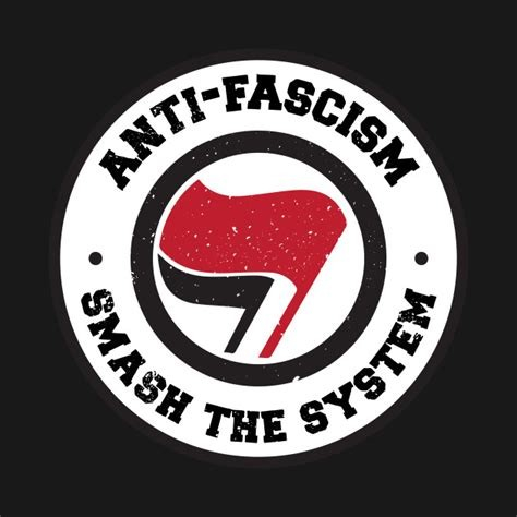 Black background with a white disc and an inner black ring.  Inside the black ring is a red and black anarchy flag.  Around the white circle is written ANTI-FASCISM SMASH THE SYSTEM