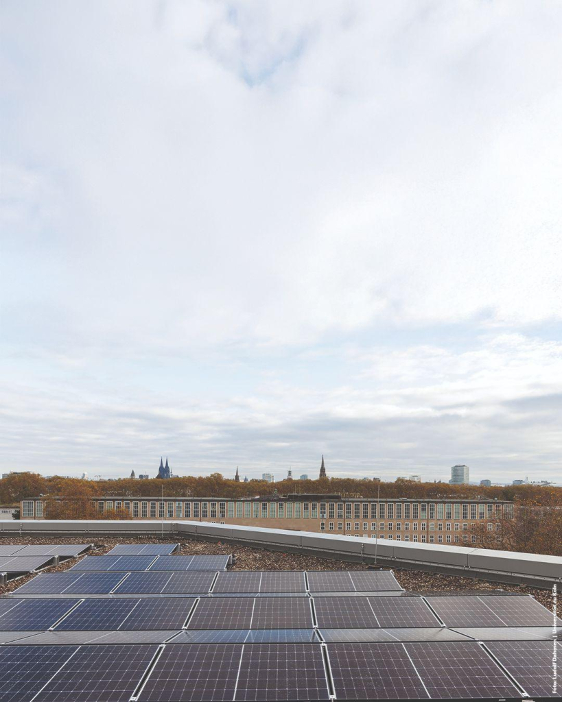 Photovoltaikanlage auf dem Dach des Kölner Philosophikums. Hintergrund: Kölner Dom und Skyline