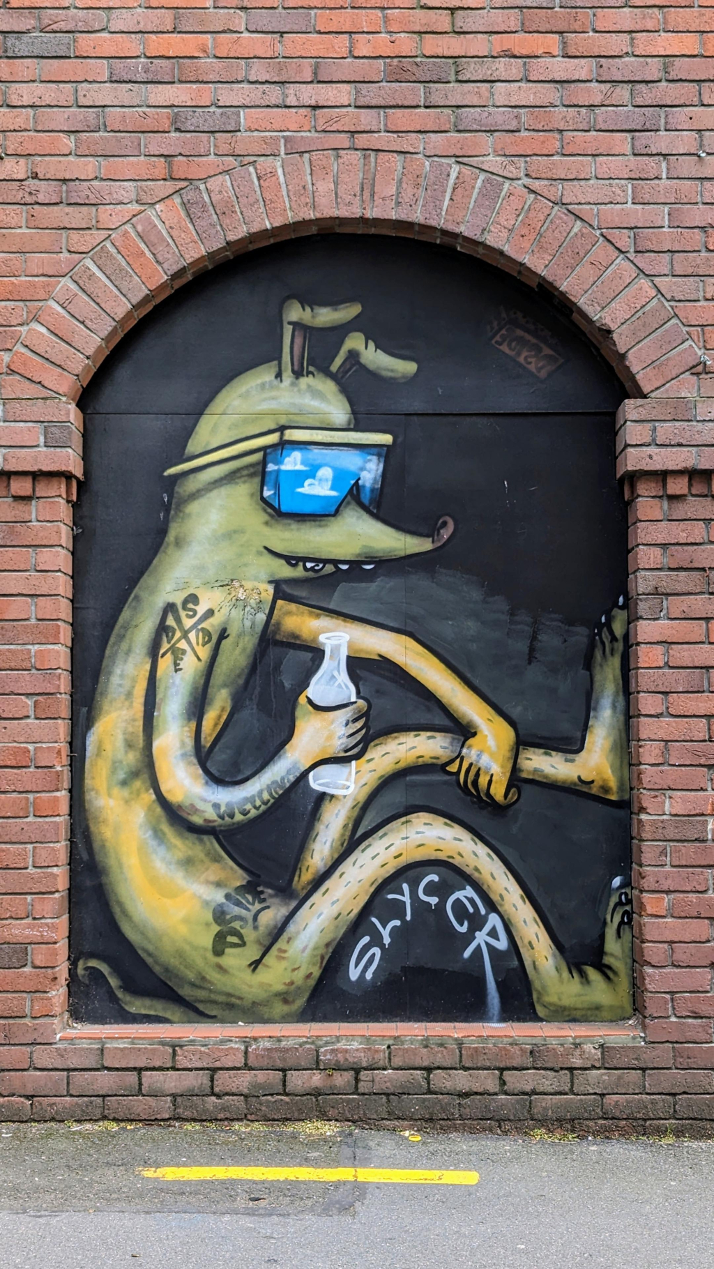 Chilled out cool cartoon character relaxed in a red brick alcove with blue sunglasses and bottle. Is it a milk bottle?