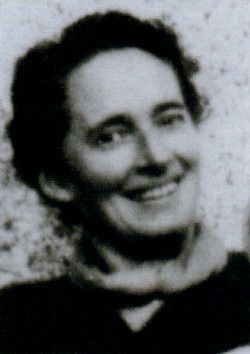 snapshot photo of Mary Herbert. She is a white woman with dark hair, wearing a neckerchief and smiling.