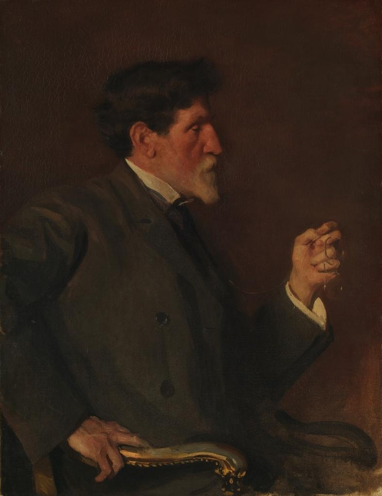 Painting of a white man with dark hair and pointed white beard sitting in profile wearing a large dark coat. His left hand is raised up holding a pair of spectacles.