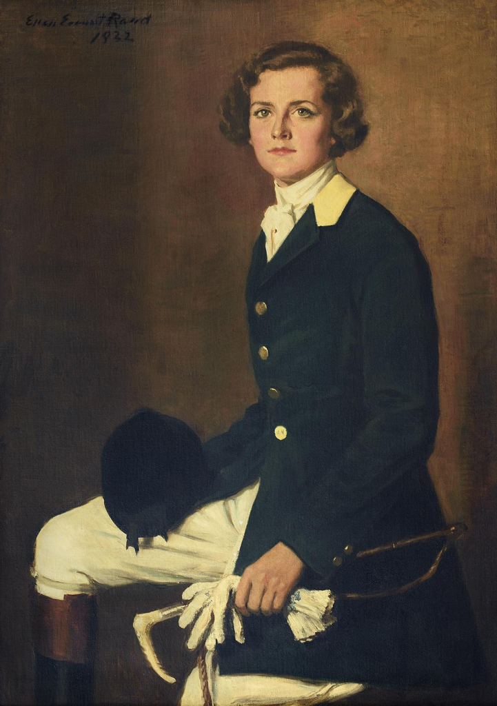 Painting of a white woman with short brown hair, seated on a stool against a brown wall. She is dressed in a riding/hunting outfit including a dark fitted coat, white trousers, and high boots, holding a hat, gloves, and crop.