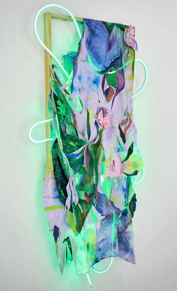 Abstract composition with various colorful layers of paint and fabric hanging on a wooden frame, and a green neon line curving around and through the piece.