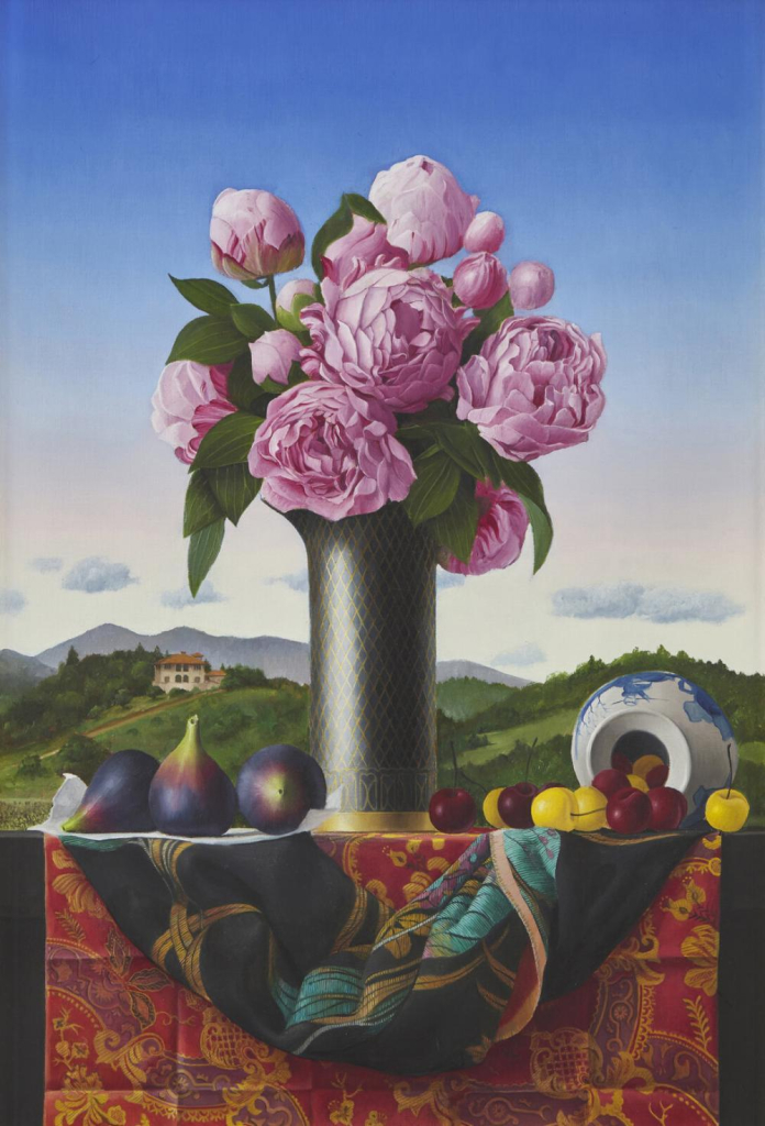 Still life painting in a photorealistic style depicting a tall vase holding an assortment of dusty pink flowers, surrounded by various fruits atop a draped patterned silk scarf and tablecloth. Behind this tableau is a green hilly landscape and a blue/white gradient sky.