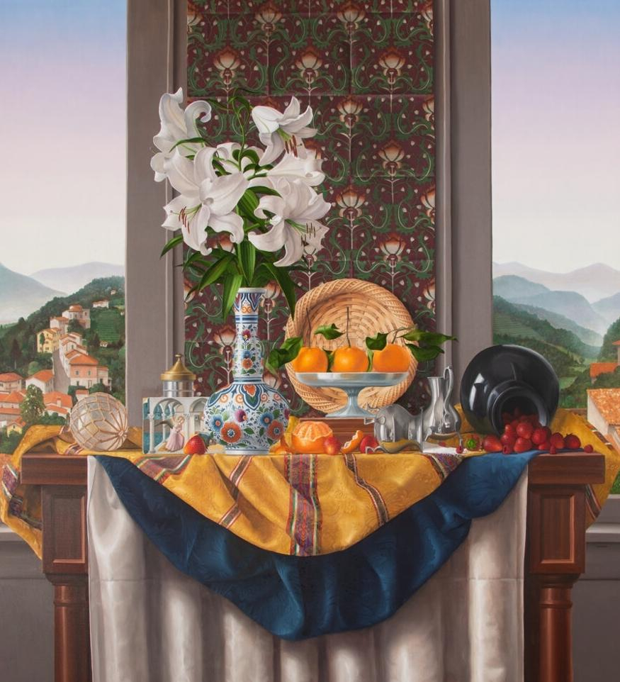 Still life painting in a photorealistic style depicting a still life of a patterned vase holding white flowers, a tray of oranges, and various tableware and fruits, atop a draped patterned silk textile and white tablecloth. Behind this tableau is a tall column covered by a floral pattern decoration, and beyond that a green mountain landscape dotted with houses, and a blue/pink gradient sky.