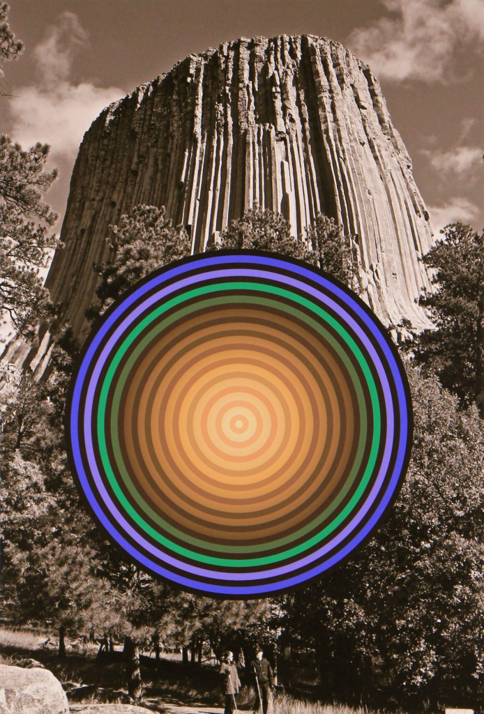 Black and white photo of Devil's Tower rising above a grouping of trees and two figures walking on a path in the foreground. Over the scene floats a large circle with several concentric circles in purple, green, and yellow with black outlines between each layer.