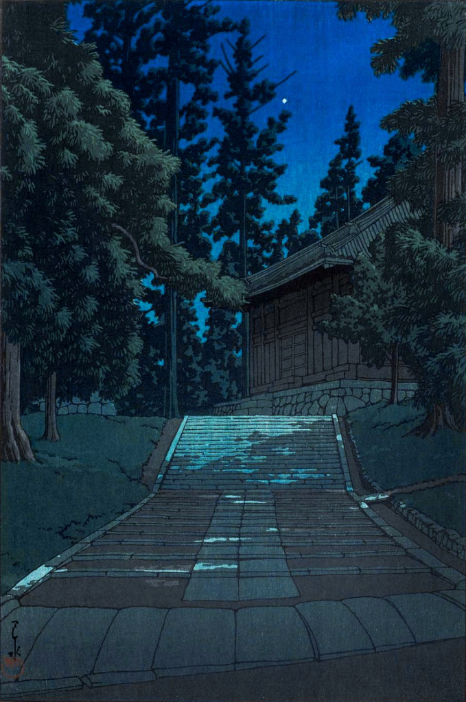 An evening view looking up the stone steps leading to the Konjikido Golden Hall at Chuson-ji. Tall trees stand to the left and right of the path, the light of an unseen moon casting dappled shadows across the stones. Ahead, at the top of the rise, a corner of the building can be seen, surrounded and backed by more tall trees. Above, a single star shines in the clear night sky