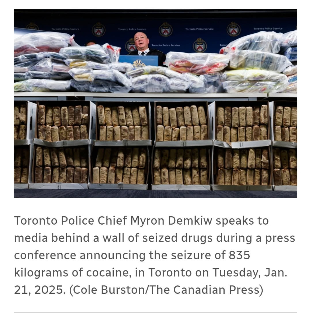 Toronto police chief sits behind a giant wall of cocaine from one (1) cocaine seizure coming into Canada from the US: 835 kg = 1840 lbs.