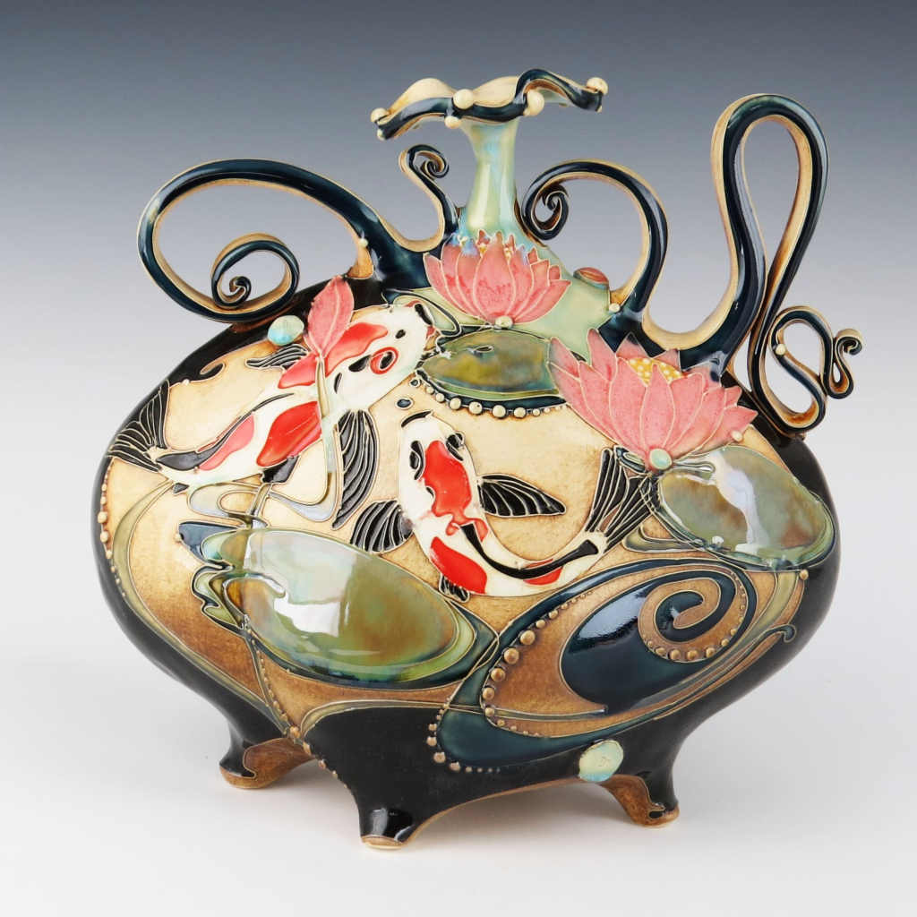 a ceramic sculpture with koi and lilies