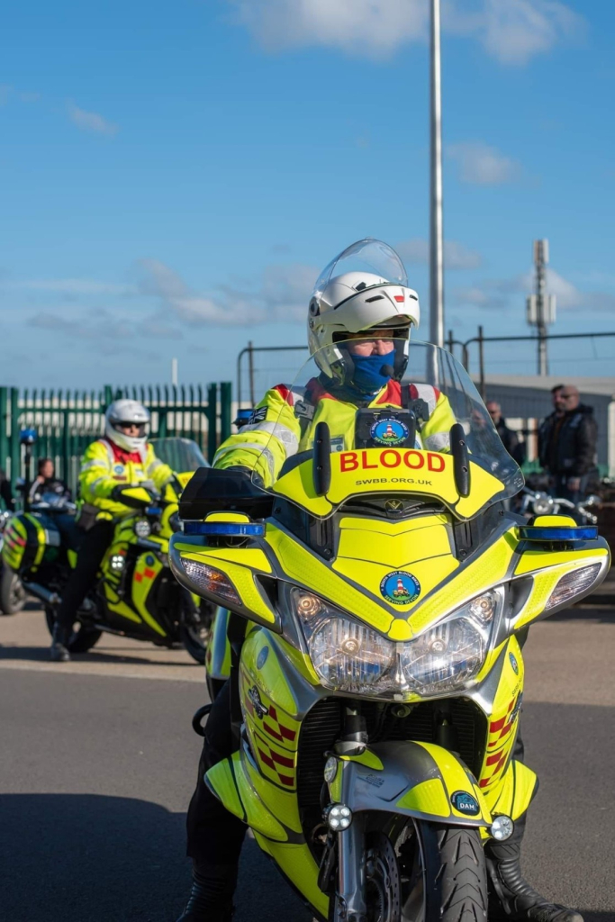 Two motorcycles in a high visibility paint job, marked with the word blood, and equipped with lights and sirens.