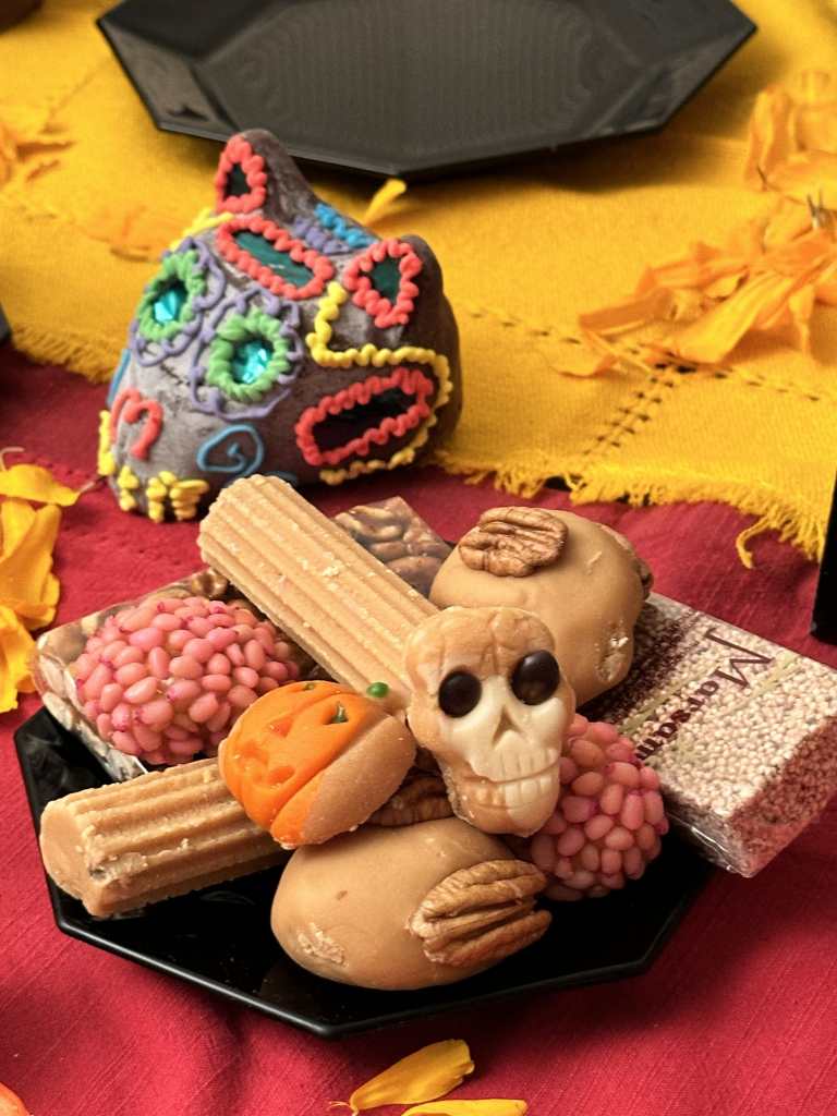 Traditional Mexican sweets and a chocolate dog skull on the ofrenda