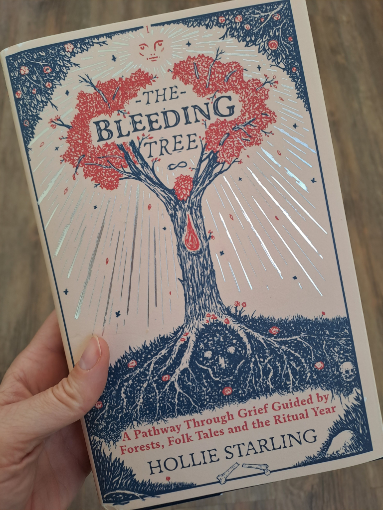 The Bleeding Tree: A pathway through grief guided by forests, folk tales and the ritual year, by Hollie Starling

Cover features a blue, white and red drawing image of a tree with red leaves and deep roots