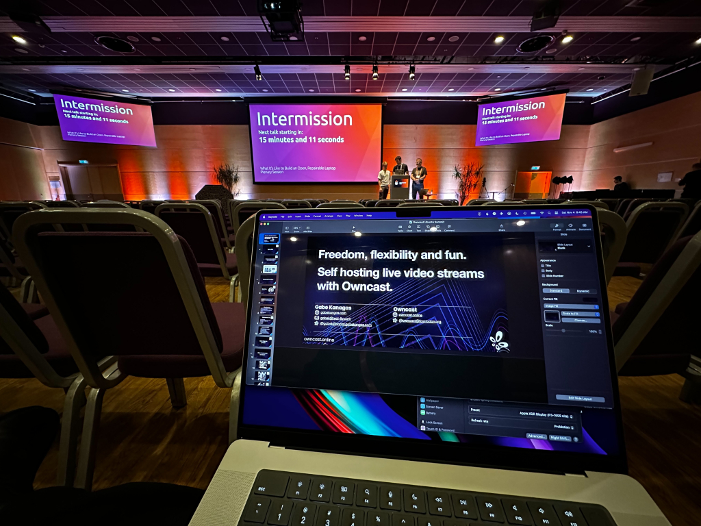 A conference room and a laptop screen with slides. 