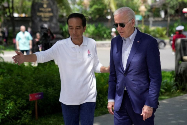 Indonesian President Joko Widodo greets U.S. President Joe Biden upon his arrival for a mangrove planting event at Ngurah Rai Forest Park, on the sidelines of the G20 summit in Denpasar, Bali,