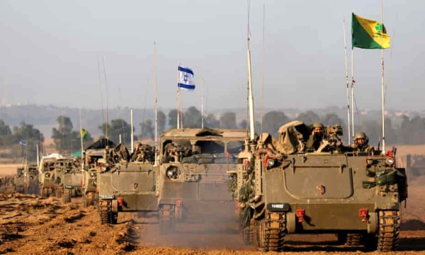 A convoy of Israeli tanks and armoured personnel carriers after leaving Gaza during the temporary truce. Photograph: Amir Cohen/Reuters
An Israeli soldier in a military vehicle after leaving Gaza during the temporary truce.