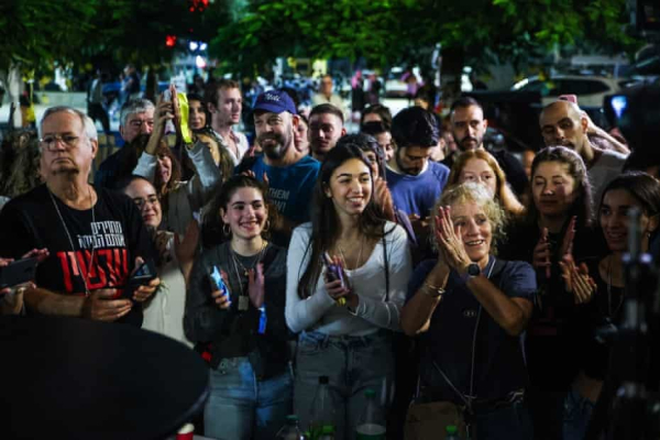 People react as the release of hostages is announced in Tel Aviv, Israel Photograph: Itai Ron/Reuters