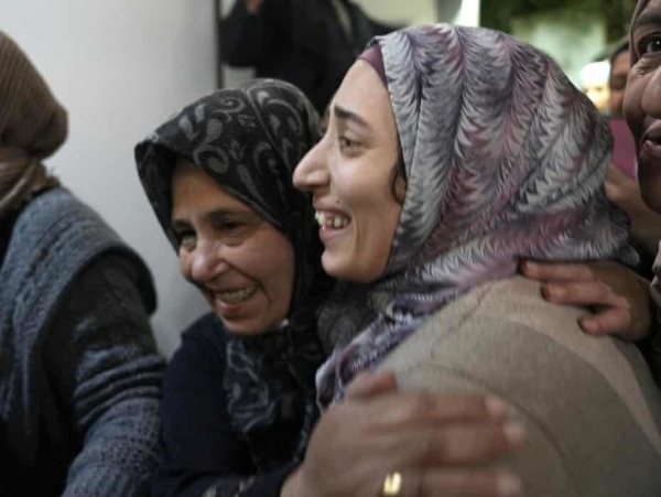 Shuruk Duveyat, right, is hugged by relatives as she arrives home after her release by Israel. Photograph: Mahmoud Illean/AP