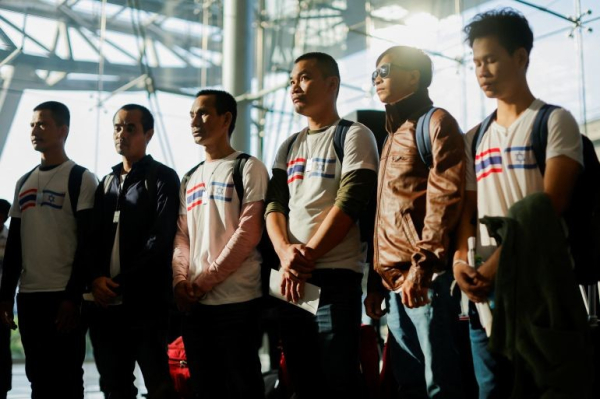 The first batch of Thai nationals who were released by the Palestinian group Hamas arrives home after being held for nearly two months in Gaza, at Bangkok's Suvarnabhumi airport in Thailand November 30, 2023 [Jorge Silva/Reuters]