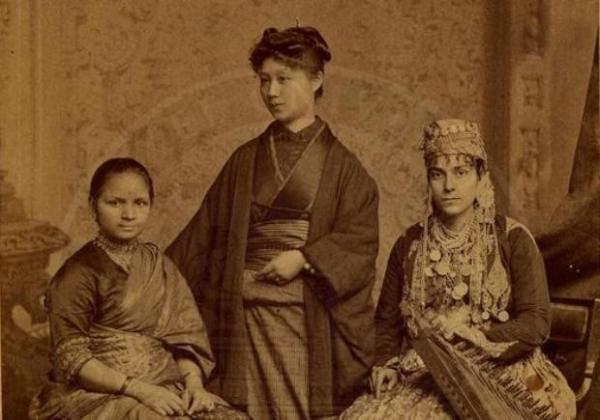 Vintage photo of the three women, all wearing traditional outfits.