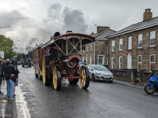 A showman's steam engine driving down a street