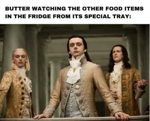 Three men wearing foppish clothes and looking effete with the caption: Butter watching the other food items in the fridge from its special tray.