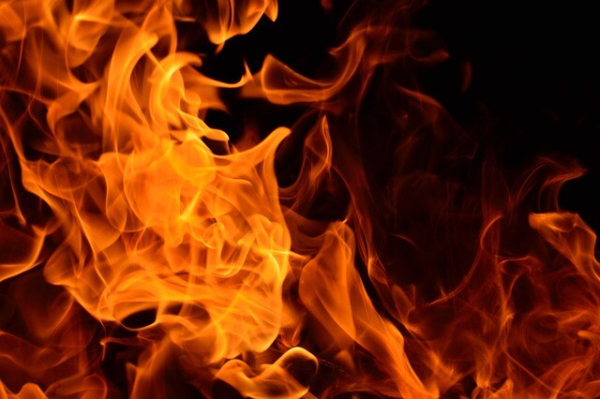 Photograph of burning fire against a black background.