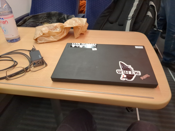 Table in from of my seat, with width twice that of my laptop. There is a sci-hub sticker on my laptop, very important detail 😸