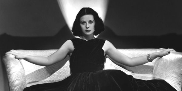 Hedy Lamarr seated in a large white divan in 1938