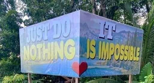 A sign with two lines reading 'Just do it' and 'Nothing is impossible'. A divider has been placed in the middle of the sign so that only half the sign is visible from certain angles. The half-signs then read 'Just do nothing' and 'It is impossible'.