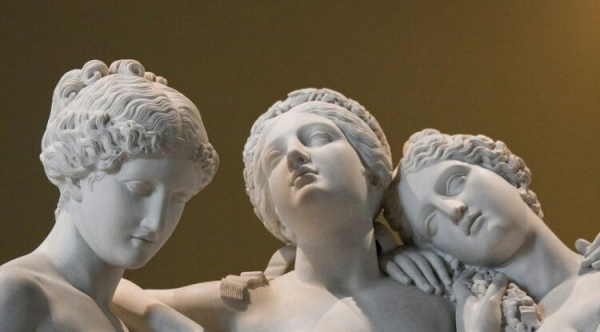 Detail of a sculpture group of the three Kharites or Graces hugging one another.