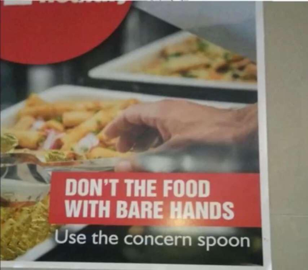 image showing a hand reaching for food and a sign that says [sic]: "Don't the food with bare hands - use the concern spoon"