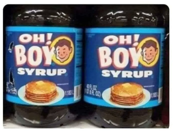 bottles on a shelf -- the labels have a stack of pancakes on them, and they say: OH! BOY syrup.