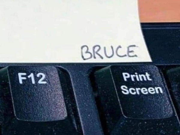 Keyboard showing F12 key an the Print Screen key, with the word, "Bruce" written above Print Screen