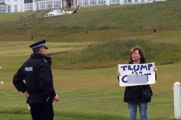 A photo of Janey Godley holding her famous "Trump is a C**T" sign

The sign has been censored in a manner similar to this alt text.